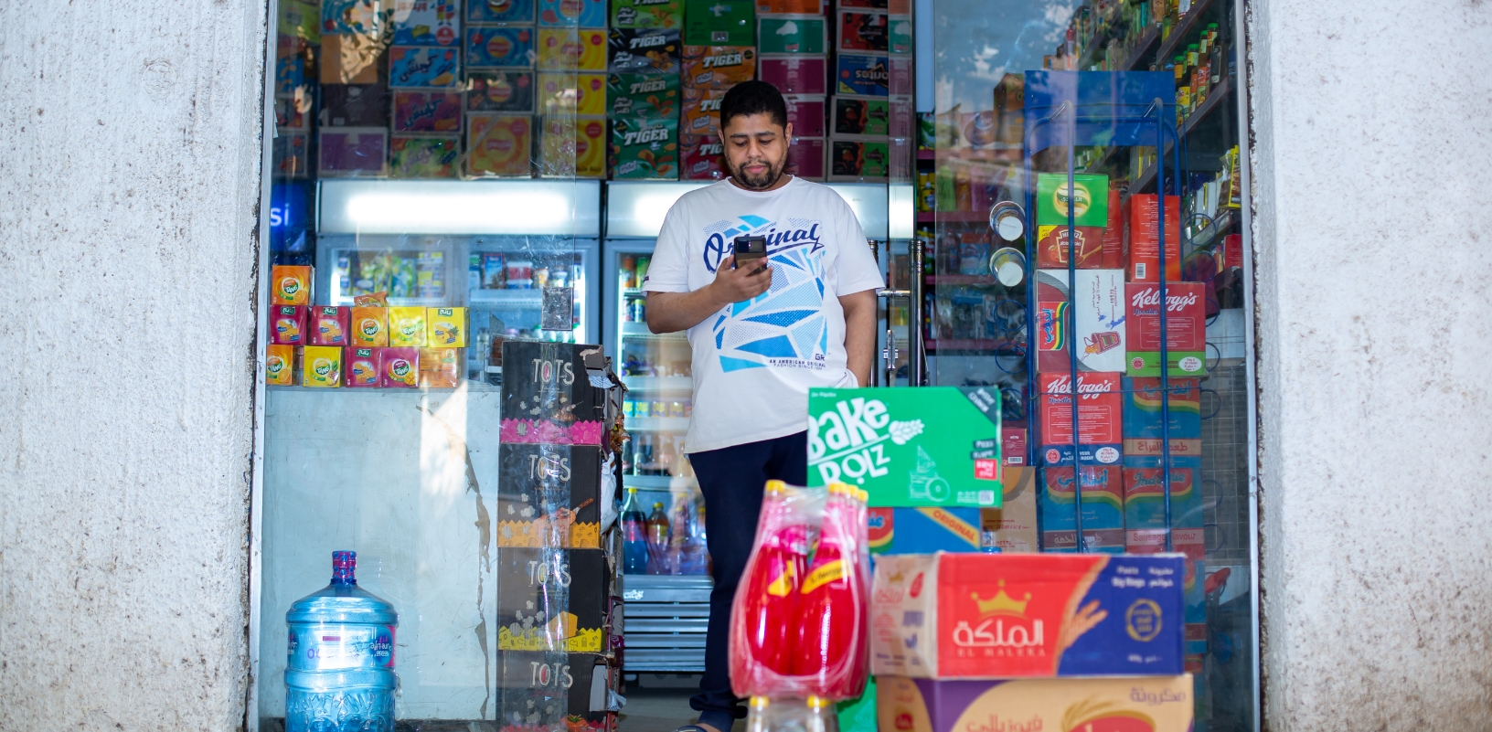 Merchant on phone in front of store