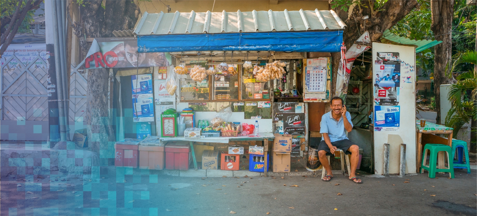 shopkeeper sitting in front of store